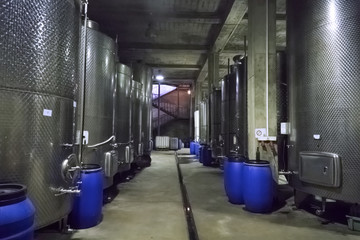 Naklejka na ściany i meble Steel barrels for fermentation of wine in winemaker factory