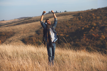 Young hiker enjoys a sunny day on the mountain