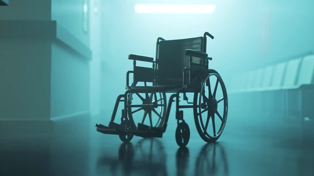 Abandoned wheelchair in empty, foggy hospital waiting corridor. Disability in 4K