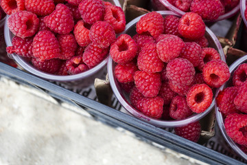 .colorful tasty raspberry in the box for sale on the beach