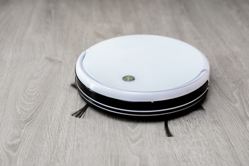 Robot vacuum cleaner on laminate floor cleans new cleaning and cleaning technologies
