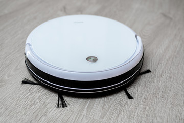 Robot vacuum cleaner on laminate floor cleans new cleaning and cleaning technologies
