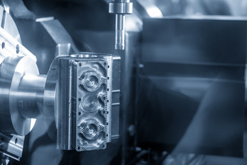 The 5-axis CNC milling machine cutting aluminium  automotive part.The Hi-Technology manufacturing process.