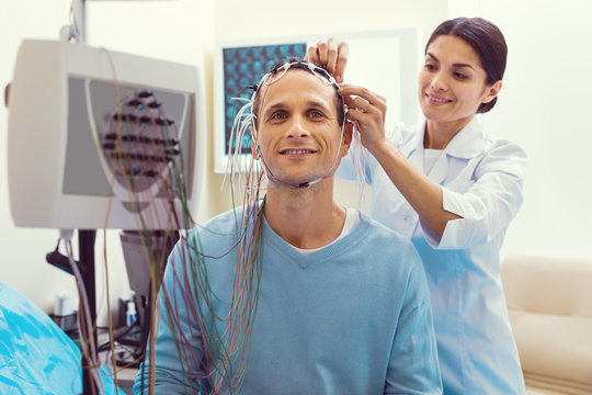 Positivity is healing. Waist up shot of a mature gentleman smiling while waiting for the nodes to be adjusted before undergoing an electroencephalography procedure.