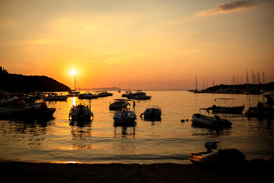 Marina with docked boats at the sunset