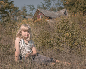 Girl in a Field Outside a House