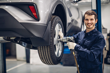 Auto car repair service center. Mechanic at work