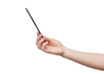 Isolated female hand with brush for makeup