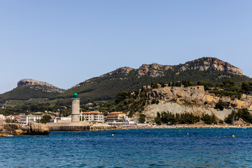 Lighthouse and houses on sea shore in Provence, France