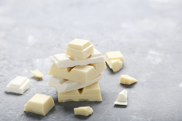 White chocolate pieces on grey wooden table