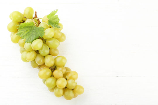 Green grape on white wooden table