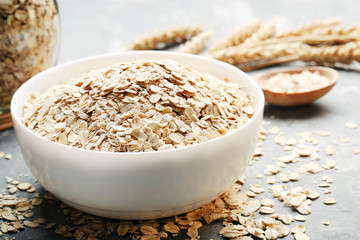 Oatmeal in bowl on grey background