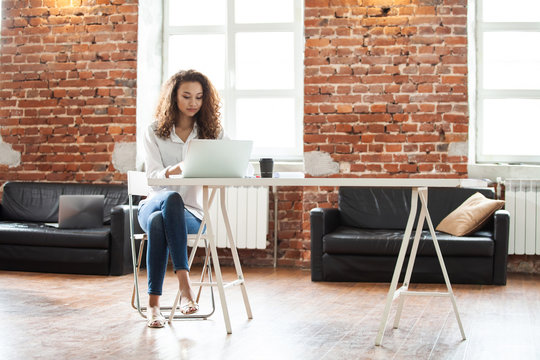 Portrait Of Cheerful Business African-American Lady Working On Laptop.