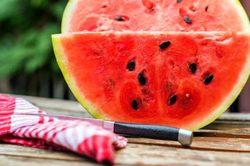 Big slice of fresh watermelon on wooden table