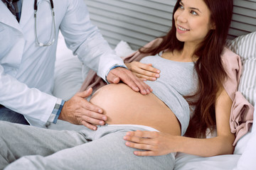 Pregnancy observation. Close up of a pregnant womans belly during a medical checkup