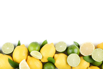 Lemons and limes with green leafs on white background