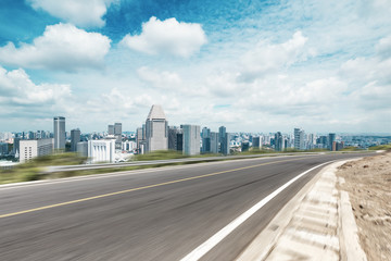 empty asphalt highway through modern city