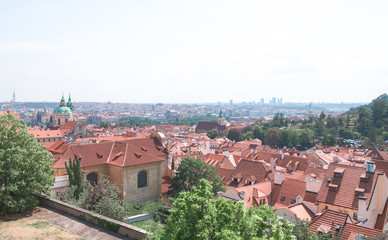 Obraz premium Prague, Czech Republic on a sunny summer day. Landscape of Prague from the observation deck. Beautiful, old, historic city with red tiled roofs top view