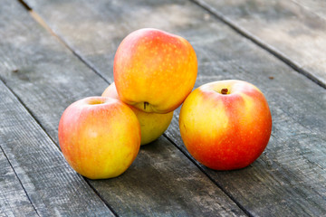 Naklejka na ściany i meble Fresh ripe apples on rustic wooden table