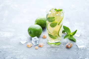 Mojito cocktail in glass on grey wooden table