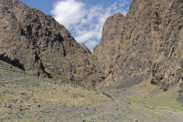Craggy, steep cliffs against a blue sky.
