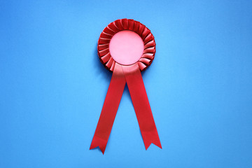 Red award rosette with ribbons - obrazy, fototapety, plakaty