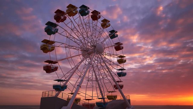 Fun Ferris wheel amusement ride, loopable carousel attraction. Epic sunset. 4KHD