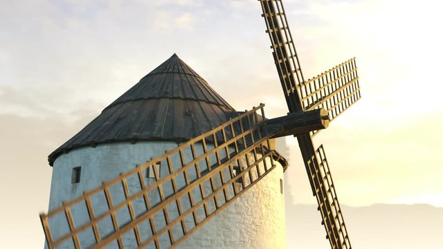 Closeup shot of a vintage Spanish windmill's wings rotating slowly at sunset. 4K
