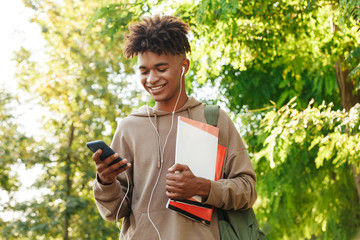 Smiling young african guy with backpack