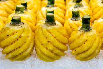 Pineapples on ice  in a glass cabinet