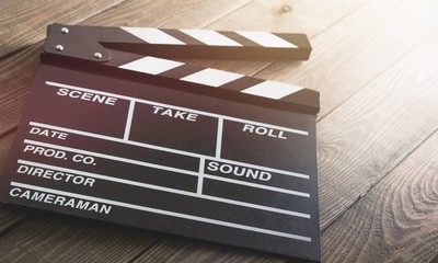Open clap board on brown wooden table
