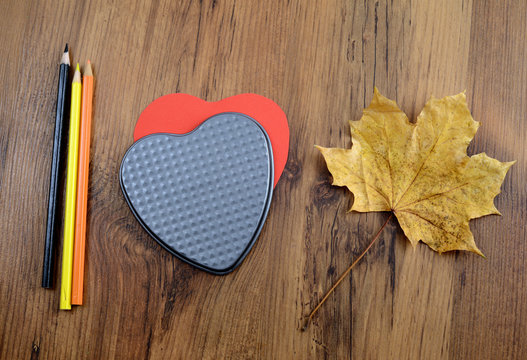 love autumn dectoration with paper heart and acorn leave on wooden background