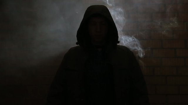A young guy in a smoky room