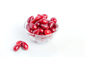 Berries are cornelian in a glass jar on a white background. Harvest, Autumn, Vegetarianism