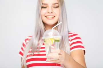 Health, people, food, sports, lifestyle and beauty content - Smiling Young Woman with glass of Water with lemon