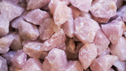 Rose quartz crystals background, often used as home decoration or talismans for its healing properties, or romantic energy, or used in ceremonies and rituals for its symbolic aura of love - obrazy, fototapety, plakaty