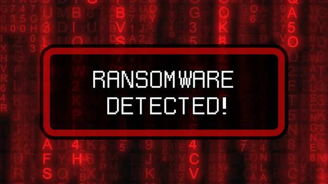 The text Ransomware Detected, appearing on a board over random symbols falling down (code rain, a popular sci-fi movie effect), changing their color from green to red.
