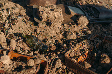 broken bottle and rusty used cartridges from weapons
