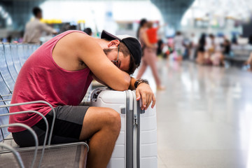 Man sleeping while waiting on the train station