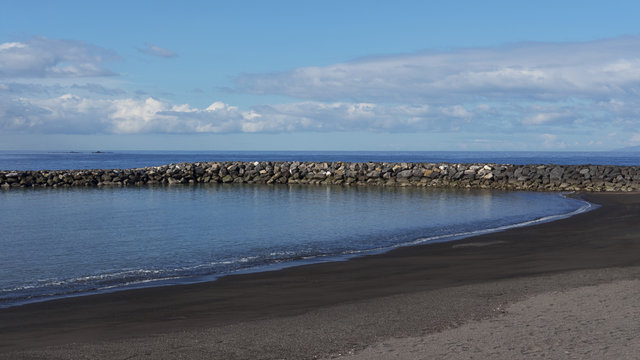 Playa del Duque, new black sand extension beach, early morning, with calm waters and no tourists yet, in Tenerife, Canary Islands, Spain