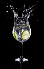 gin tonic cocktail splashing isolated on black background