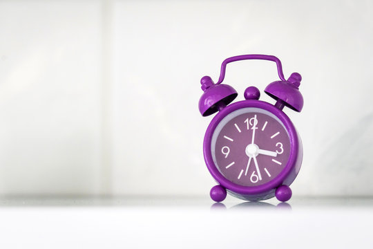 Purple alarm clock in a bright room