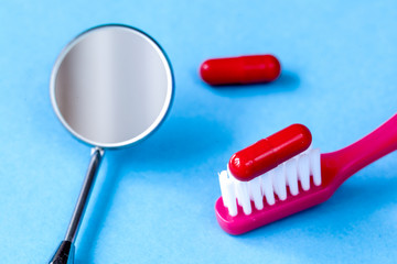 concept tooth pain - dentist tools, tablet at blue background