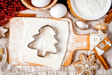 cooking christmas gingerbread on wooden background top view