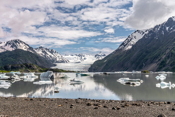Grewingk Lake with floating iceburgs reflecting in the water. Grewingk Glaceir in the background