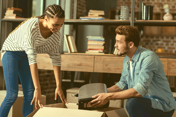 Almost done with packing. Positive minded girlfriend and boyfriend talking while packing stuff and moving into their new house together.