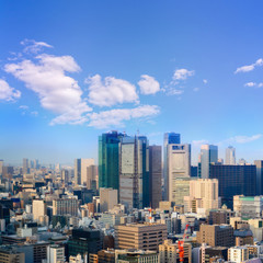 Naklejka premium cityscape of tokyo city skyline in Aerial view with skyscraper, modern business office building with blue sky background in Tokyo metropolis city, Japan.