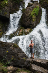 Man at waterfall in Altai Mountains territory