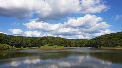 Fototapeta na wymiar clouds reflected in a lake at Lone Elk Park near St. Louis, MO