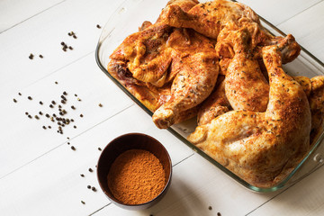 chicken legs prepared for roast with spices